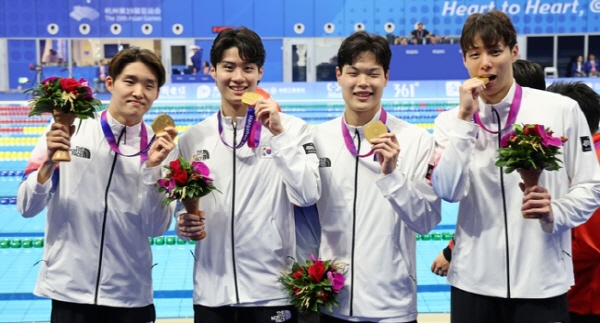 김우민, 황선우, 이호준, 양재훈(왼쪽부터)이 25일 중국 항저우 올림픽 스포츠센터 수영장에서 열린 2022 항저우 아시안게임 수영 남자 800m 계영 결승 시상식에서 금메달을 들고 포즈을 취하고 있다. [사진=뉴시스]